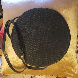 Vintage round purse-black pleather. It is good shape. Sold as is.
